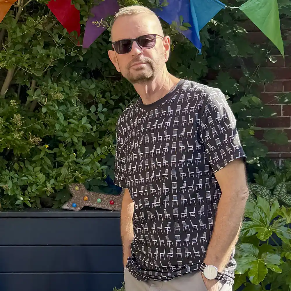 Colin Walton wearing Mid Century Chairs patterned T-shirt
